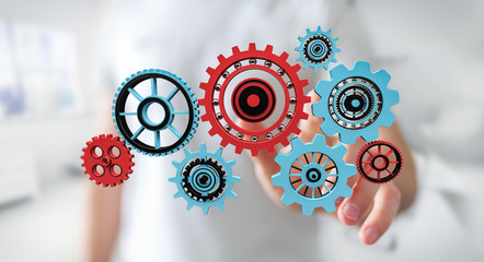 Businessman touching floating gear icons in his hand 3D rendering