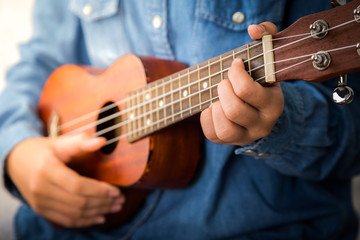 Fototapeta na wymiar Playing ukulele.