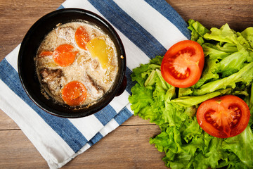 Beef meat stewed with potatoes, carrots and spices in ceramic pot