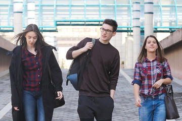 Three students walking in the campus