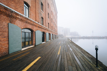 Fototapeta na wymiar Henderson's Wharf, on a foggy day in Fells Point, Baltimore, Maryland.