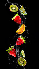 Fresh fruits falling in water splash