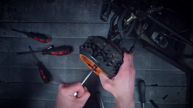 4K Technical Shot Of Mechanic Taking of Tyres from RC Car