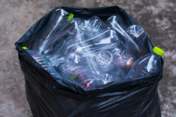 pile recyclable plastic bottles in trash bag