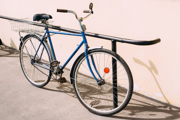 Fototapeta na wymiar Old Rarity Bicycle Parked Next To Wall