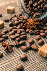 Coffee beans into glass jar table with sugar and anise