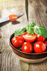 tomatos in a bowl on a wooden table