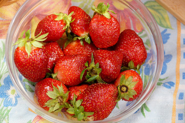 Fresh strawberry in a transparent salad bowl