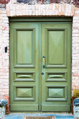 Green wood doors. Entrance to the old manor. Background. Facade.
