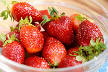 Fresh strawberry in a transparent salad bowl