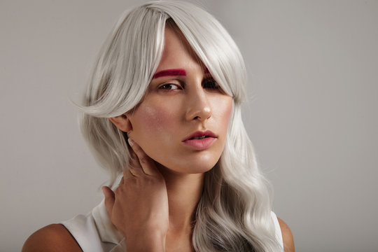 creative coloured hair of model. grey hair pink brows