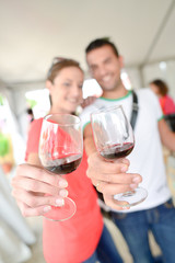 Couple holding up glasses of wine