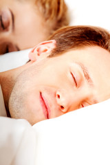 Young couple sleeping in bed