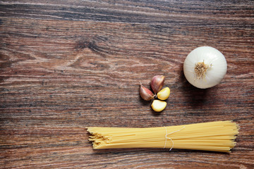 Ingredients for spaghetti bolognese on wooden background.