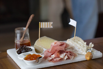 Gourmet appetizer board with cheeses and prosciutto. 