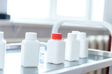 a container of medication in a laboratory biologist arms