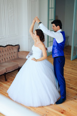 bride dancing with the groom in the room