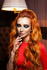 Red-haired model posing in a cozy cafe