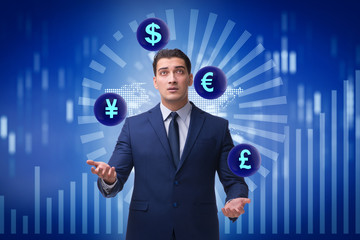 Businessman juggling between various currencies