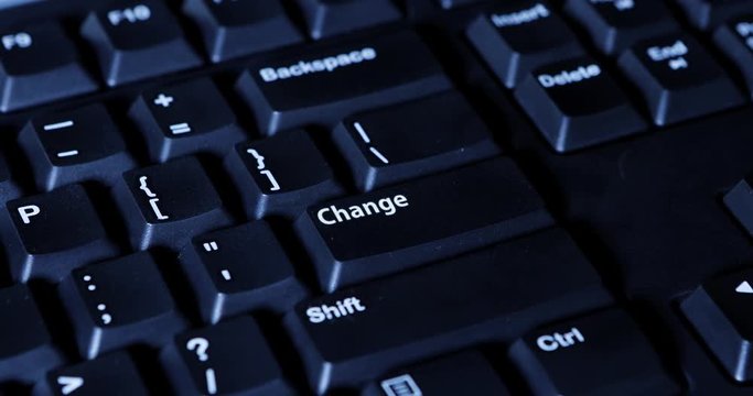 Close up of human finger pressing a change button on the computer keyboard