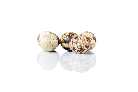 Raw guail eggs isolated on white background