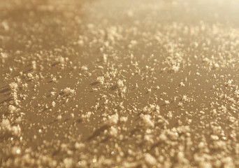 Snow flackes on metal car surface with blur effect.