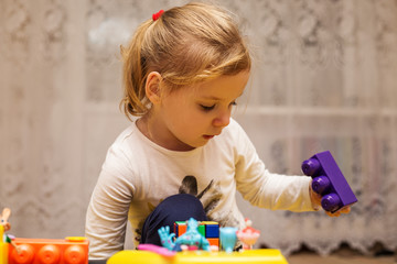 little girl playing with toys