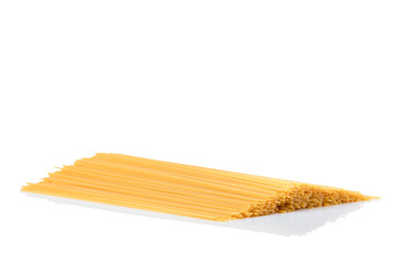 Uncooked dry fettuccine pasta isolated on a white background