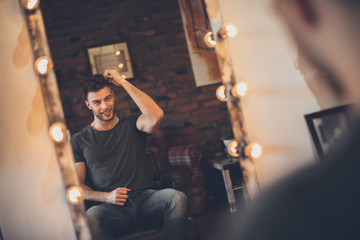 Handsome man at the hairdresser getting a new haircut