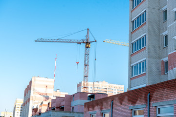 New high-rise modern apartment buildings construction in process ob bright sunny day front view horizontal