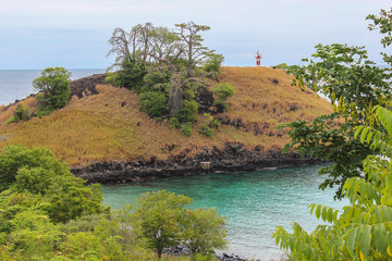 Lagoa Azul ( Blue Lake) a beautiful beach with baobab and a lighthouse up the cliff in Sao Tome and...