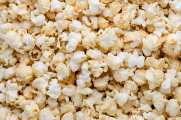 Popcorn background. Caramel sweet corn. Cinema snack.