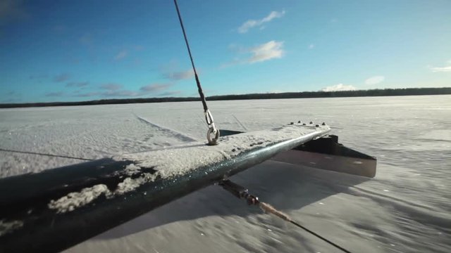 The skate of iceboat rides on the ice.