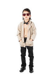 A curly-haired boy in sunglasses stands and looks into the camera. White background.