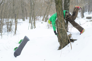 Winter sports, snowboarder stuck in a tree.