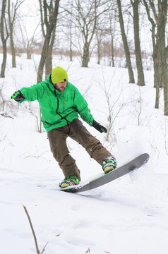 Snowboarder coming down the hill on a snowboard.