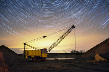 Crane at the nightsky filled with stars at the sand mine © Piotr Jankowiak