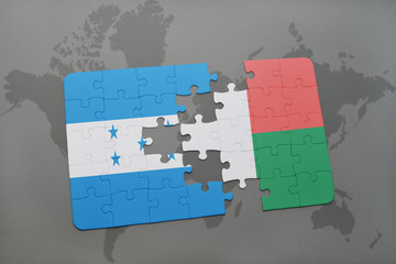puzzle with the national flag of honduras and madagascar on a world map