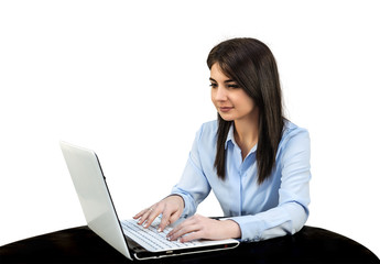 Young girl sitting in the office in front of computer, she is typing on a keyboard. White isolated background.