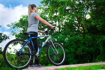 Beauty Young Blonde Woman Walking In Nature With Bicycle