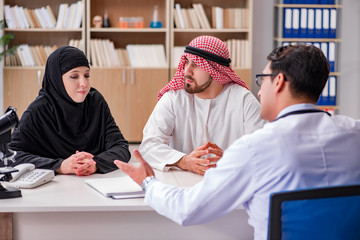 Doctor consulting arab family at hospital