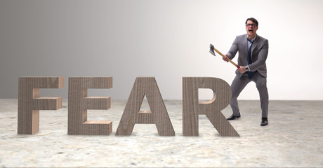 Angry man with axe axing the word fear