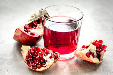 pomegranate juice with seed on stone table background