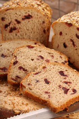 Whole grain bread with cranberry on a wooden board