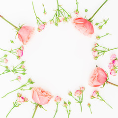 Round frame with pink roses on white background. Flat lay, top view. Floral background.