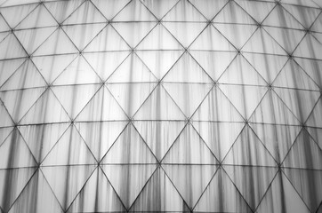 Monochrome black and white photo of elements modern building. Dome trimmed with triangular aluminum panels. Abstract bark background