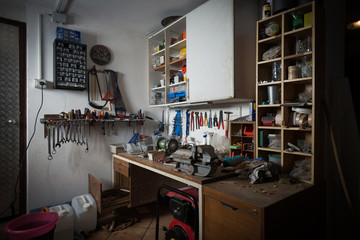 Messy workshop, complete chaos on workbench, unorganised basement or garage. Efficiency and...
