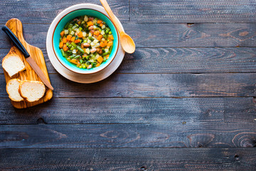 Fresh vegetable soup made at home, on wooden rustic table,  top view