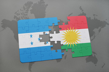 puzzle with the national flag of honduras and kurdistan on a world map