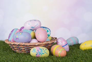 Fototapeta na wymiar Colorful Easter Eggs and Basket Against a Multicolored Background
